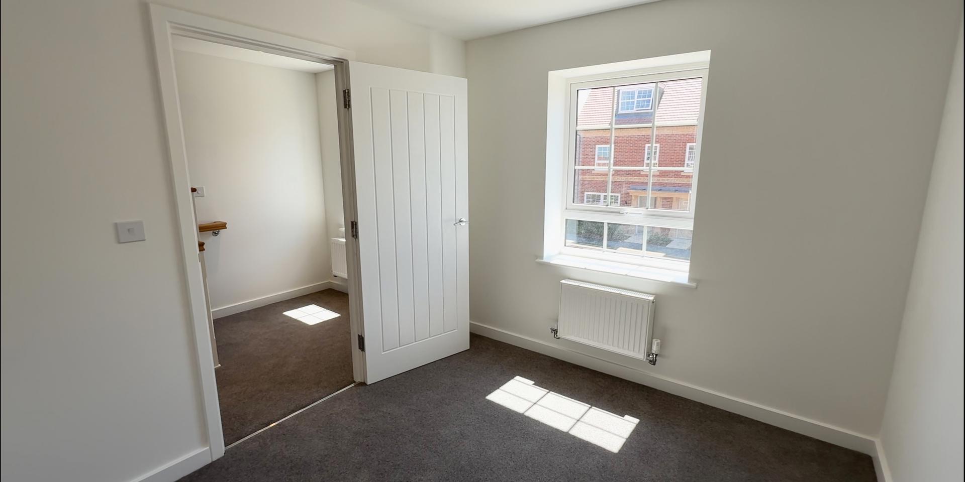 Bedroom 3 is a single bedroom with a large window