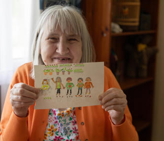 A service user showing a drawing of five people and plants
