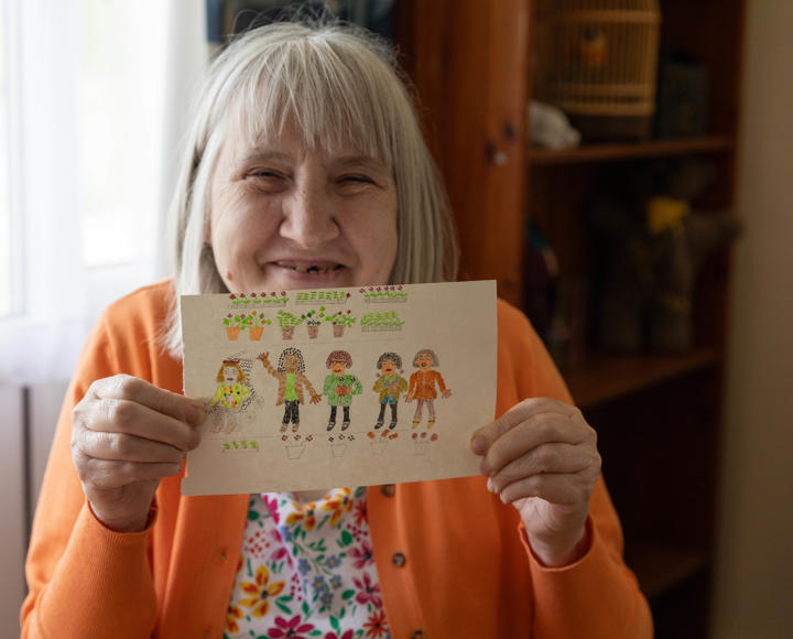A service user showing a drawing of five people and plants