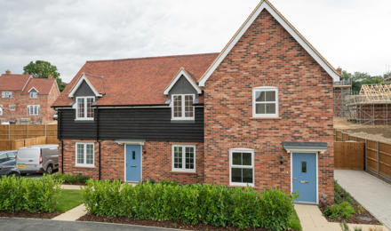 Two houses on a new development, with a small front garden.