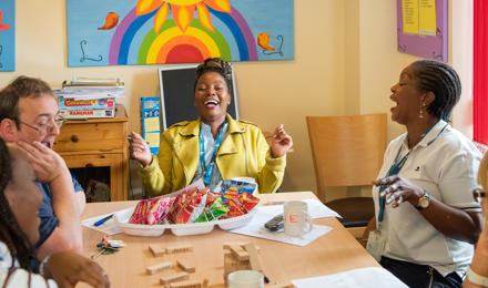 Staff and service users enjoying lunch at a supported housing scheme