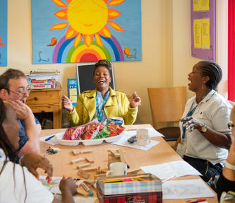 Staff and service users enjoying lunch at a supported housing scheme
