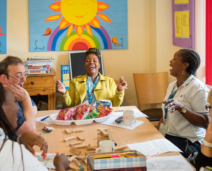 Staff and service users enjoying lunch at a supported housing scheme