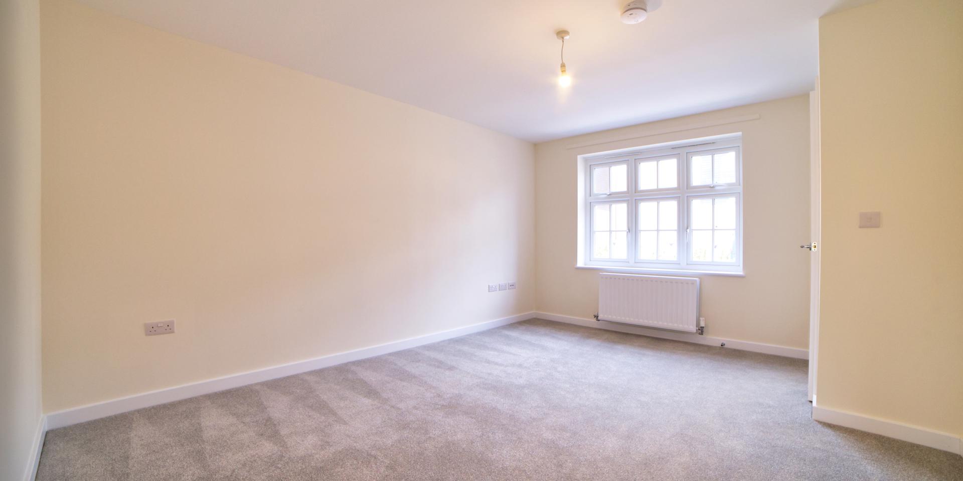 The spacious living room with large window