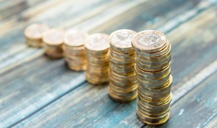 Piles of pound coins decreasing in size, showing that the amount of money available is decreasing