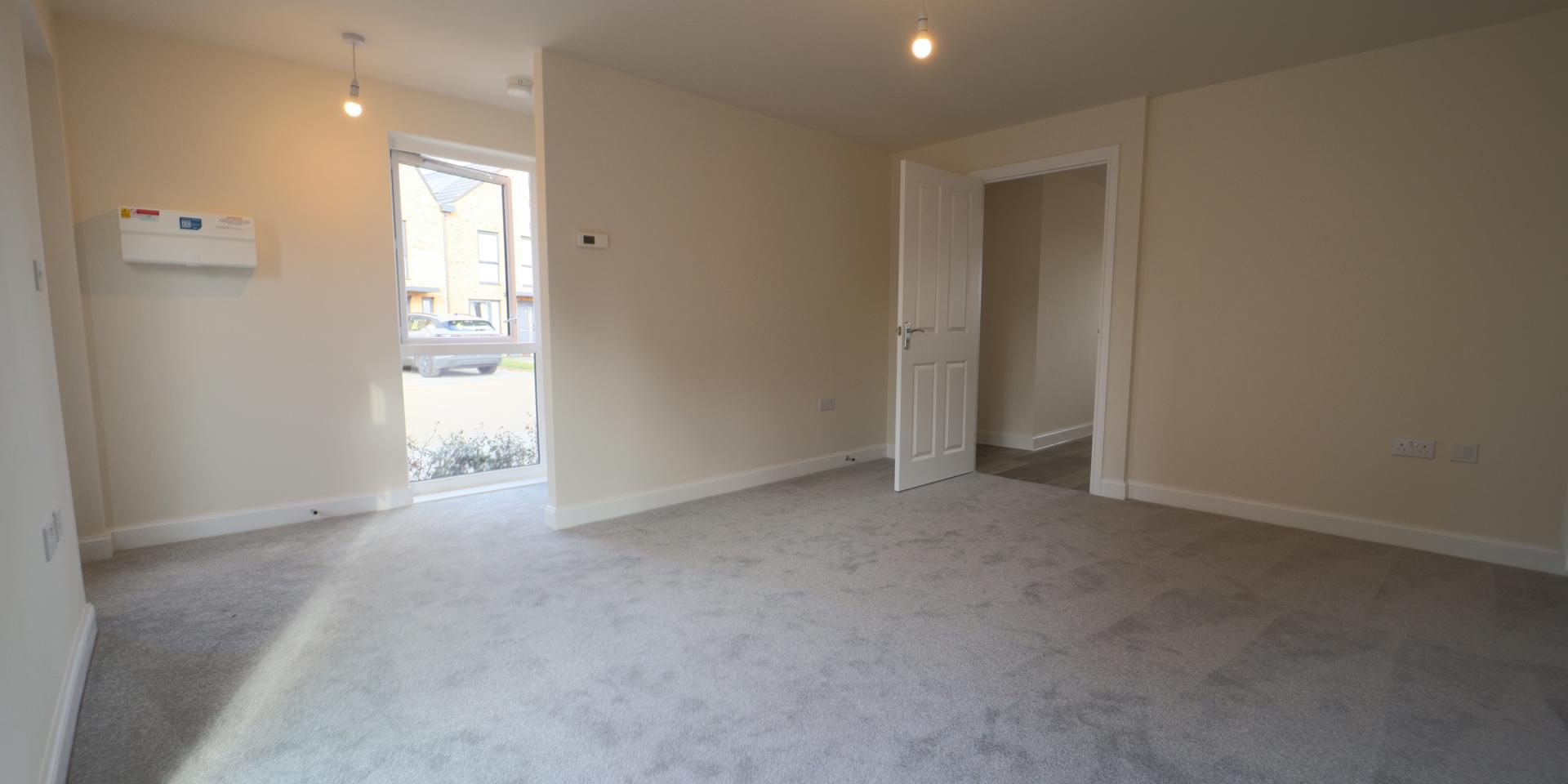 The front door leads into the living room and the stairs are behind a wall