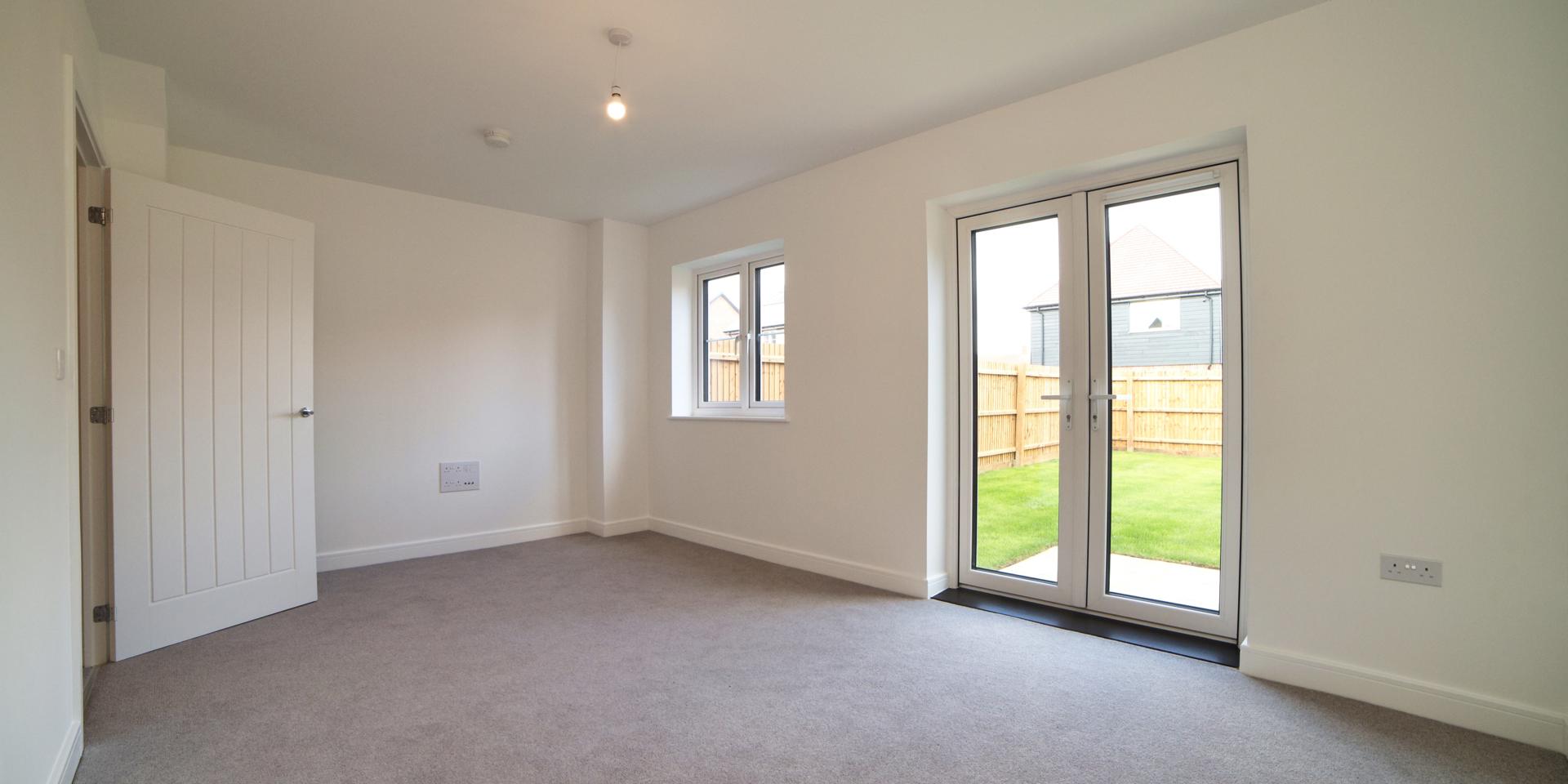 The living room has a double patio door leading out into the rear garden as well as a double window over looking the garden