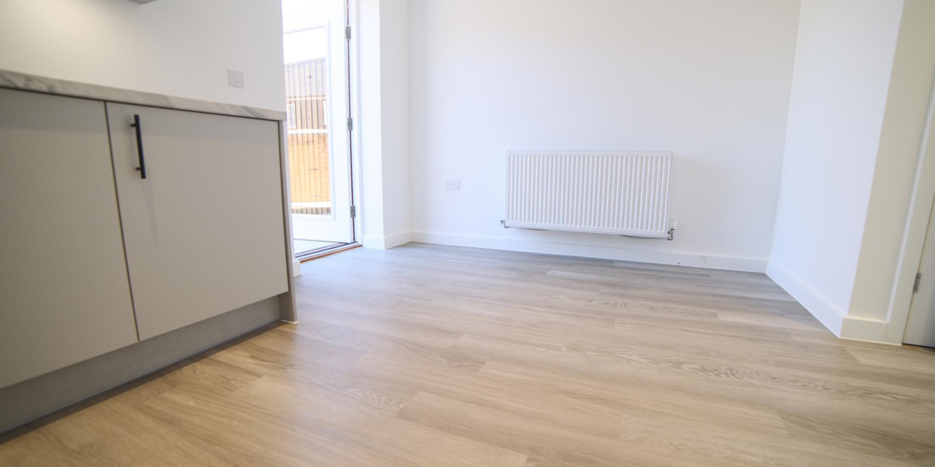 The kitchen is a kitchen diner with an area for a dining table and chairs.