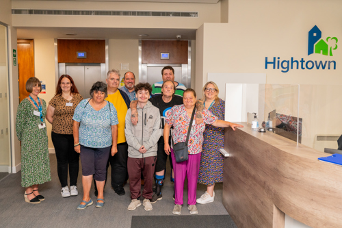 Five men and five women from the VoiceBox group, standing next to Hightown logo