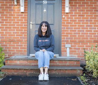 A mum sat on the steps outside of her new shared ownership property