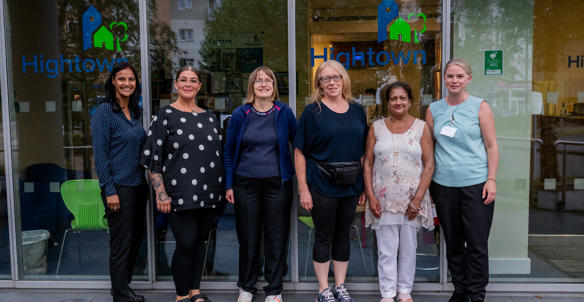 residents voice and scrutiny panel members stood outside the Hightown head office with two members of staff.