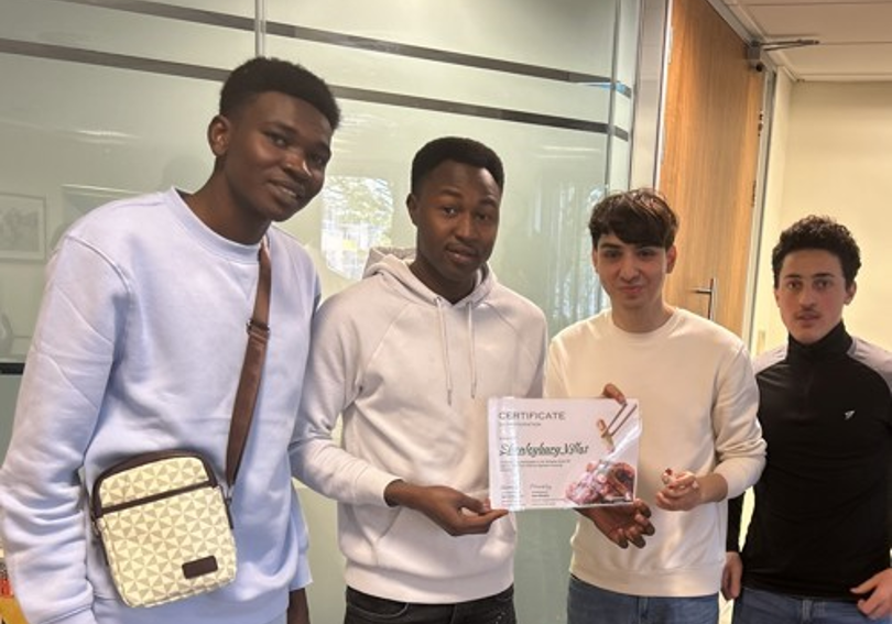 Four participants of the cook off holding a certificate at Hightown House