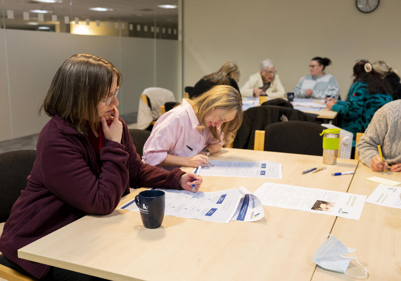 Poeople reviewing a leaflet at Hightown House