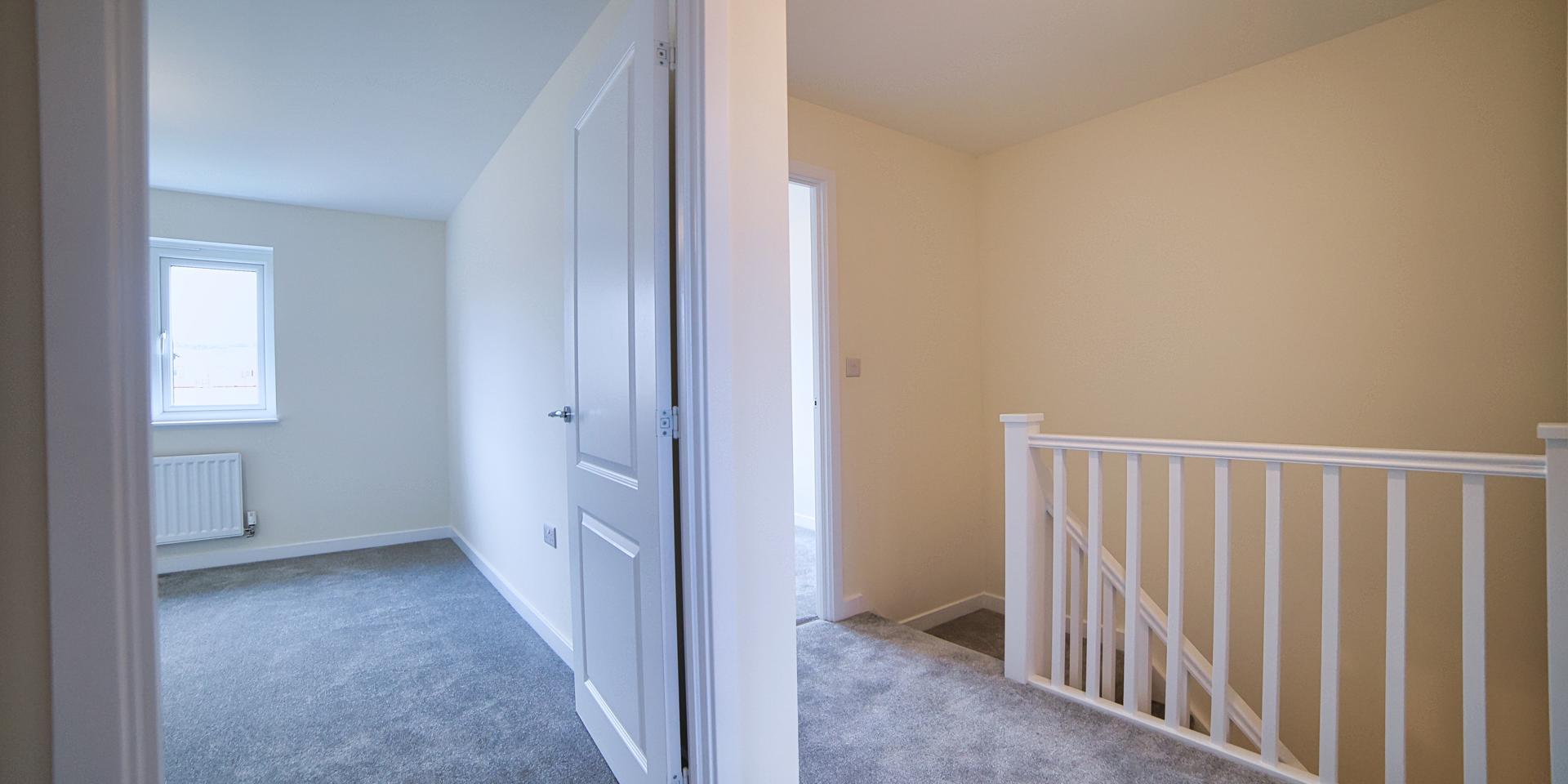 A view from the top of the landing looking into one of the double bedrooms