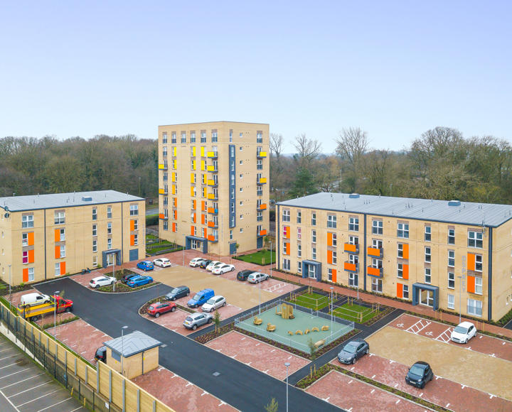 Blocks of flats with colourful balconies. In colours such as yellow and orange. 
