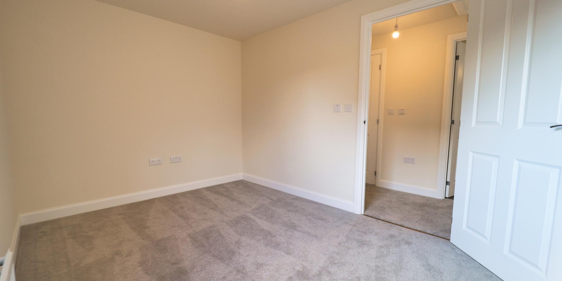 Bedroom 2 will fit 2 single beds and it has a light grey carpet