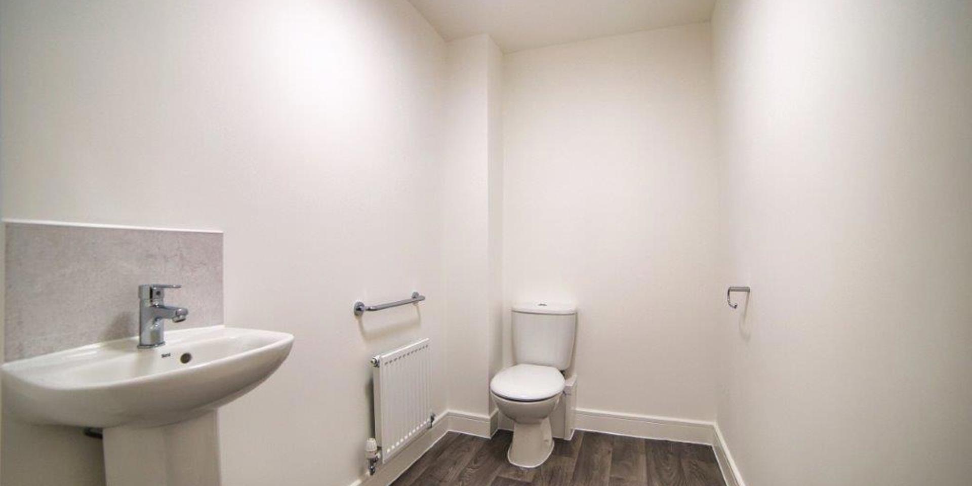 Downstairs cloakroom with wash hand basin and toilet