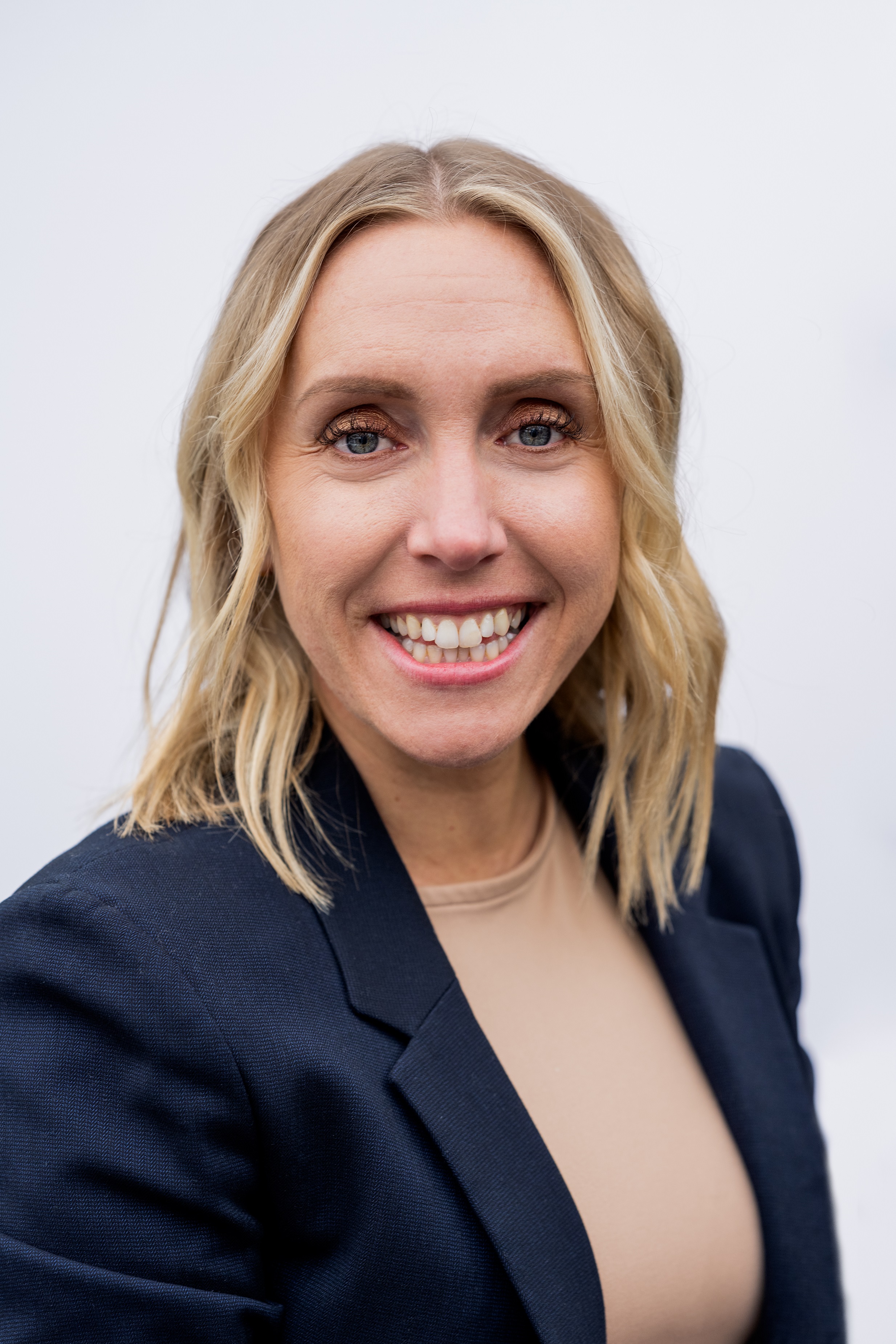 Director of care and supported housing. She is wearing a black blazer and beige top, with shoulder length blonde hair and blue eyes. 