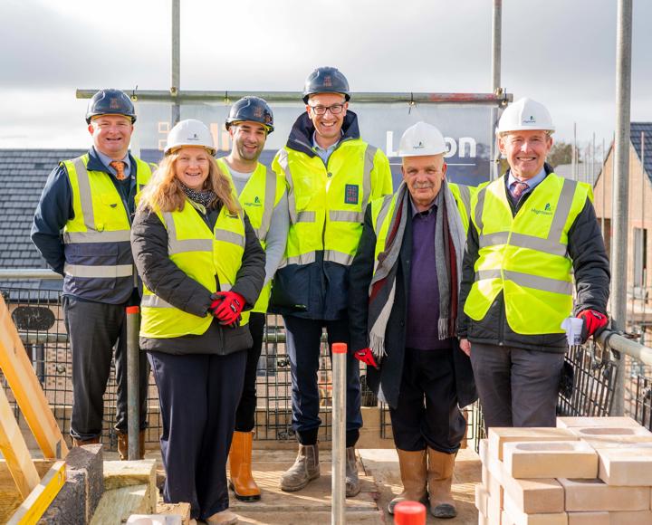 Staff from Hightown, Hill Group and Luton Council standing in hi-vis jackets on a building site