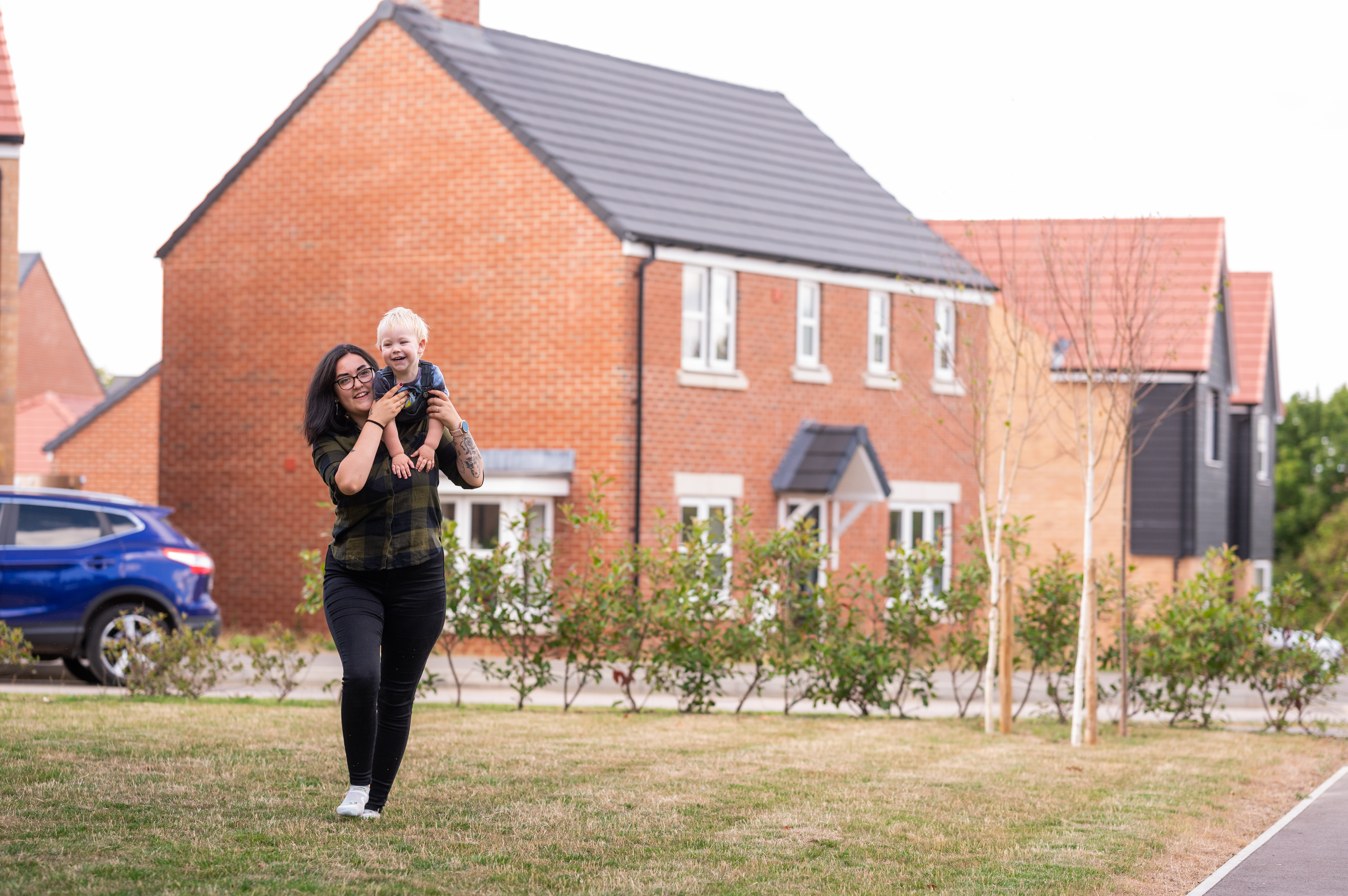 Resident and her son playing outside in the communal area