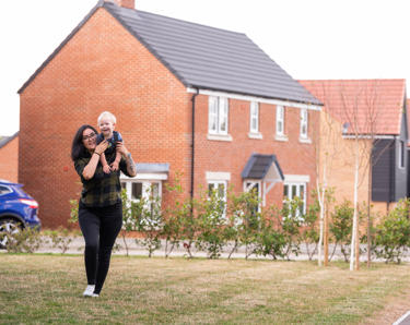Resident and her son playing outside in the communal area
