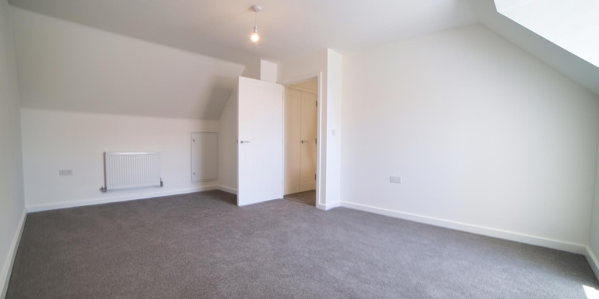 Bedroom 2 is large enough for a double bed or 2 single beds and it has a slanted ceiling at both ends of the room