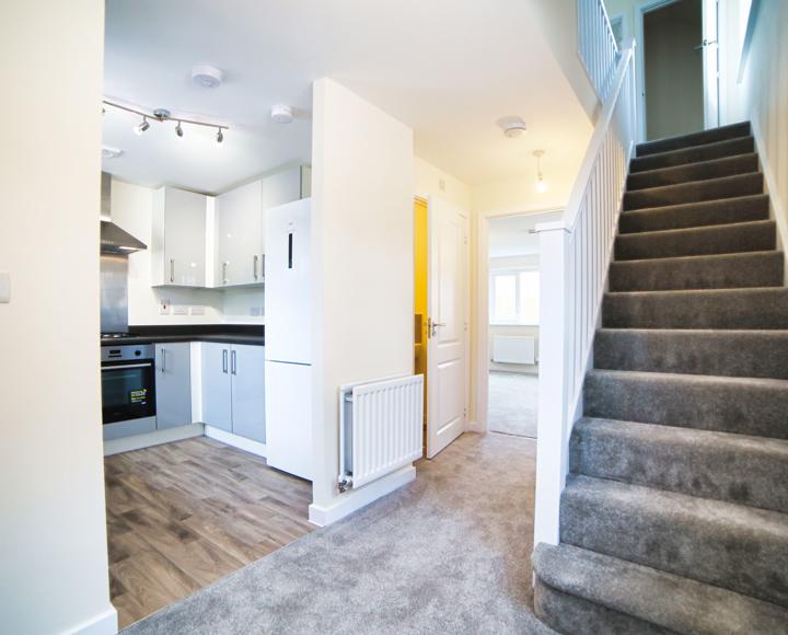 The hallway showing the entrance to the kitchen, living room and stairs