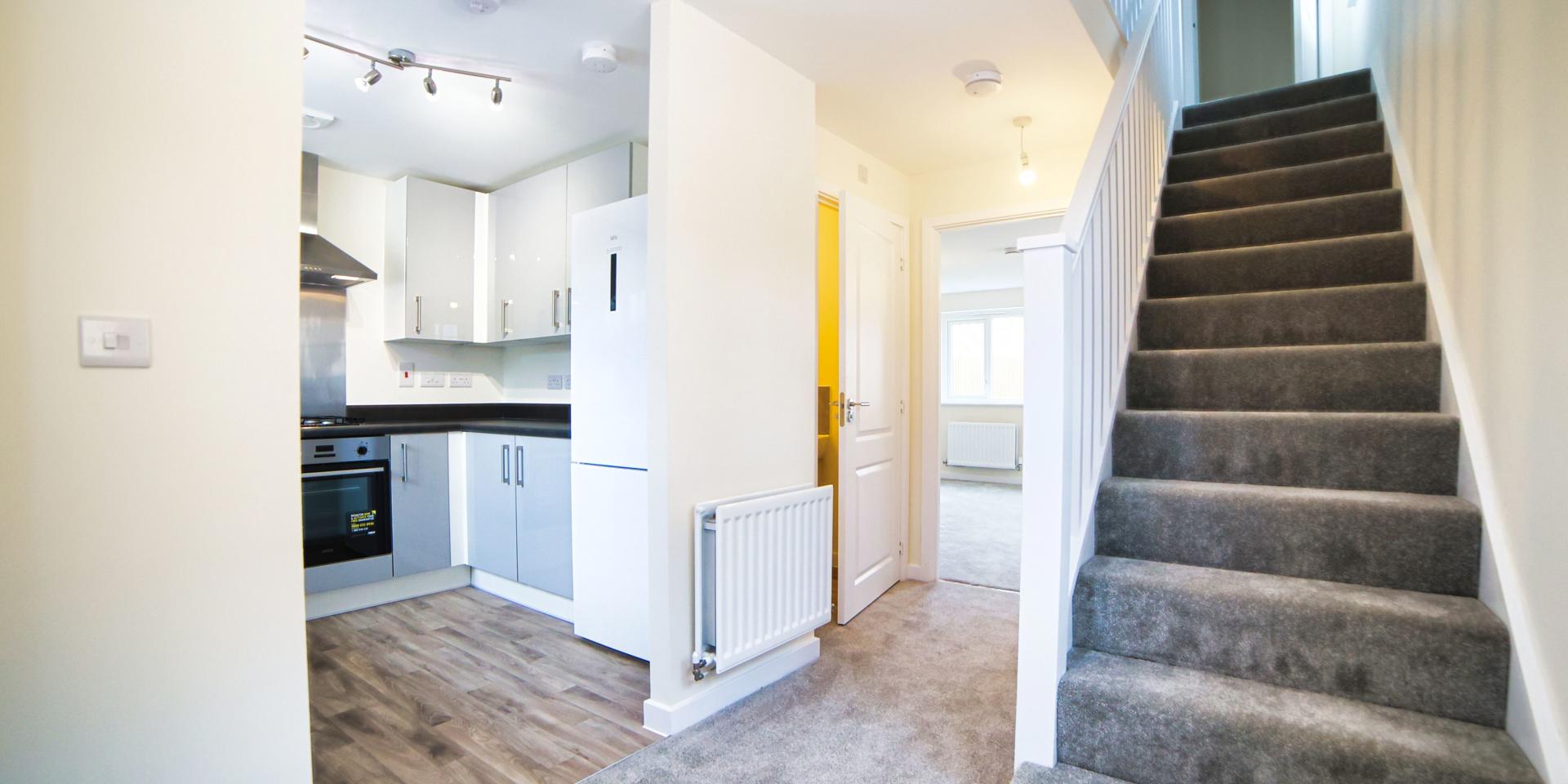 The hallway showing the entrance to the kitchen, living room and stairs