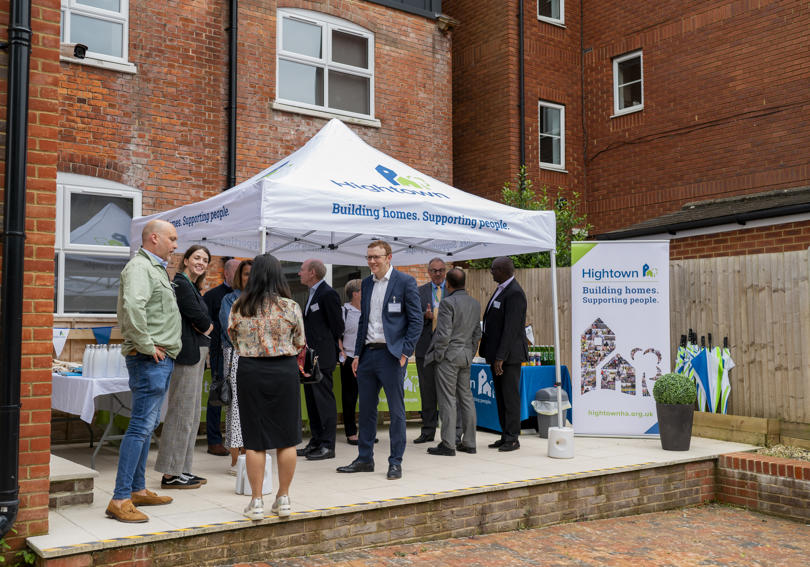Staff smiling and talking outside of Alexandra Road during opening