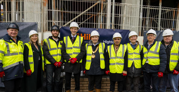 Hightown staff and others taking a group photo at Broadwater Road's bricklaying
