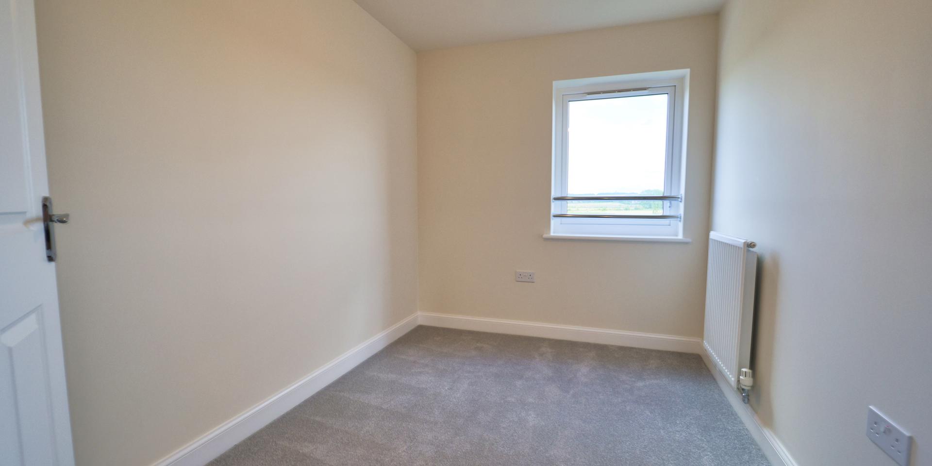 Bedroom 2 is a single bedroom with light grey carpet
