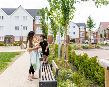 Hightown resident and her two children playing in communal area outside