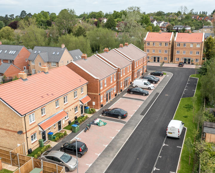 Aerial photo with the street and houses visible. 