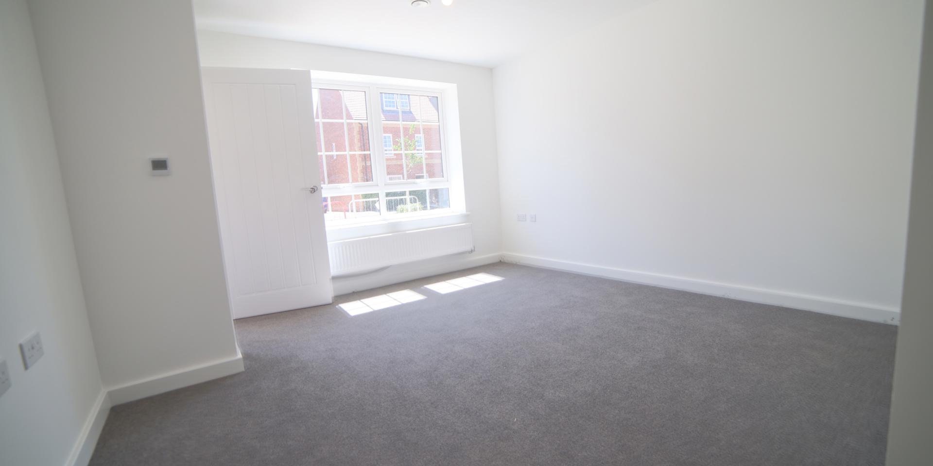 There is a large window in the living room allowing a lot of light in