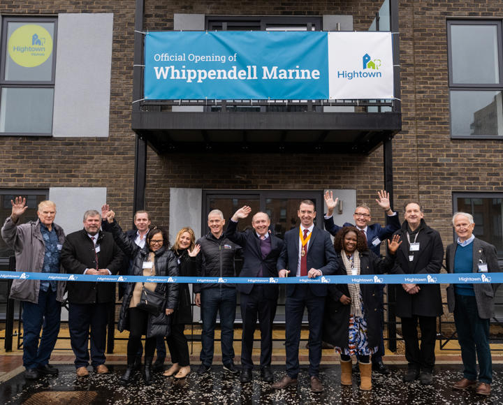 A group of official people, including the CEO of Hightown opening a new development of flats.
