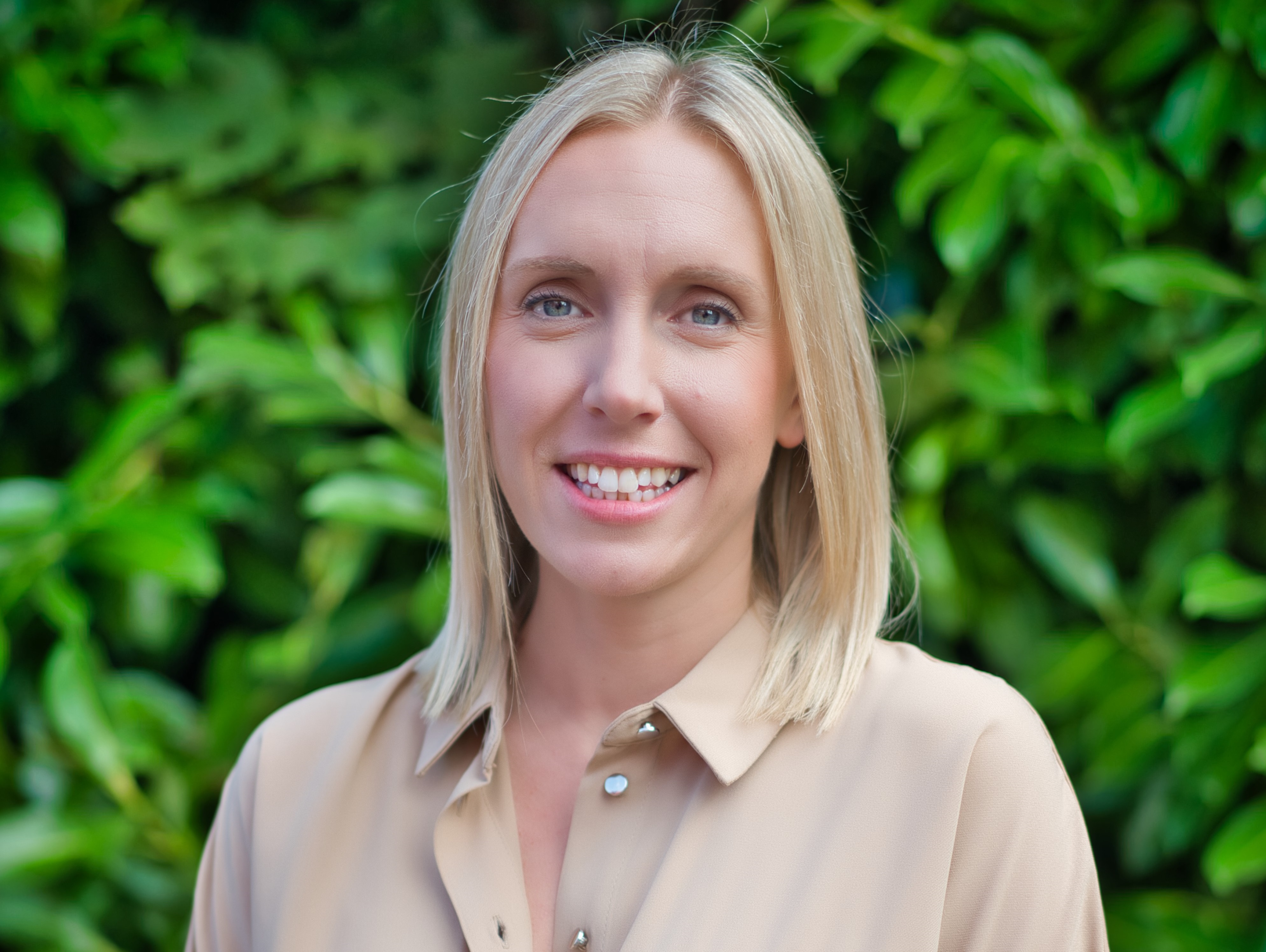 Director of care and supported housing. She is wearing a beige blouse and has shoulder length blonde hair and blue eyes. 