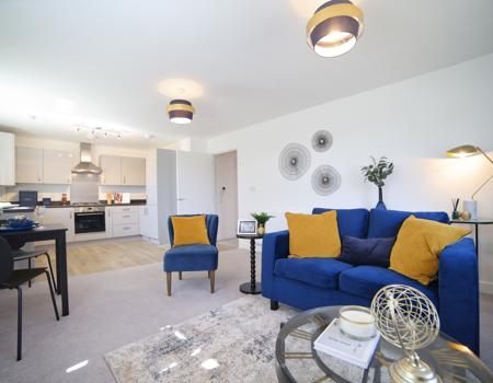 The living area is open plan to the kitchen and dining area. There is room for a small dining table and chairs plus sofas