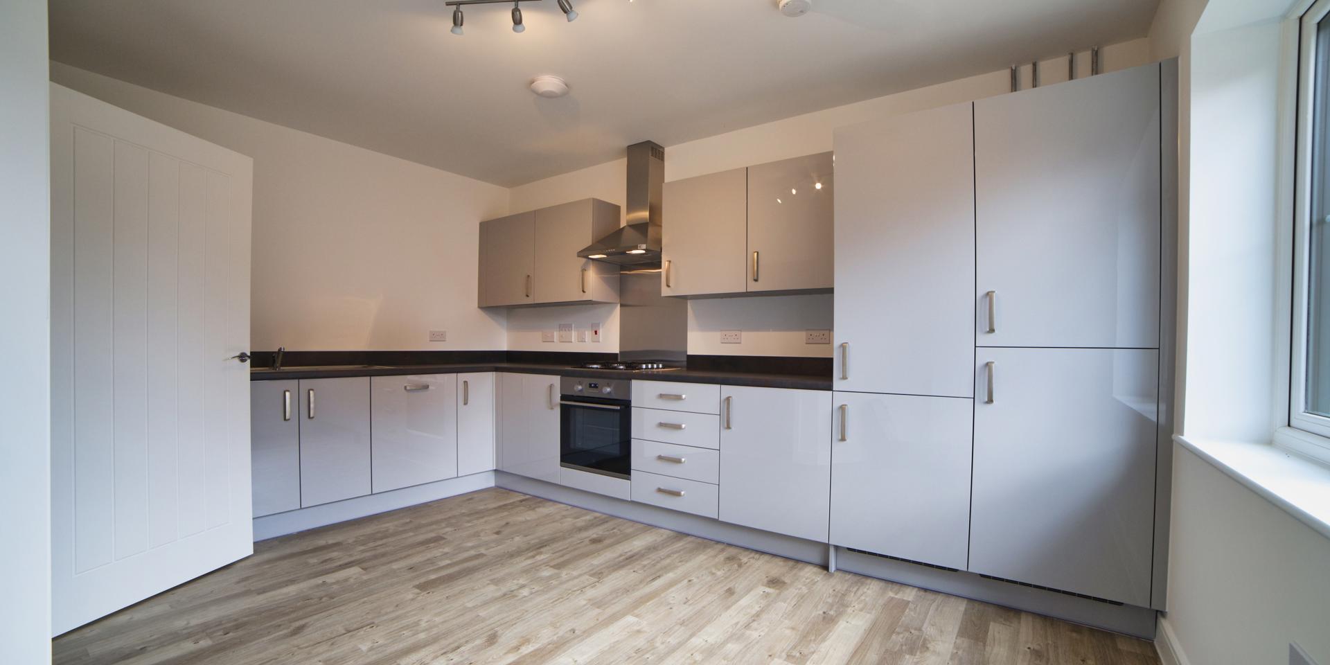 The kitchen/diner comes with integrated appliances and sits to the front of the property