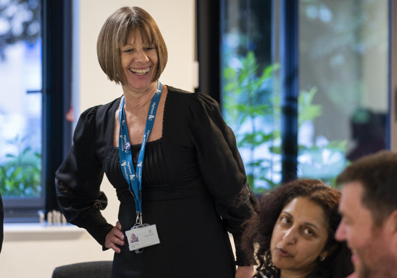 A voicebox member smiling during a meeting