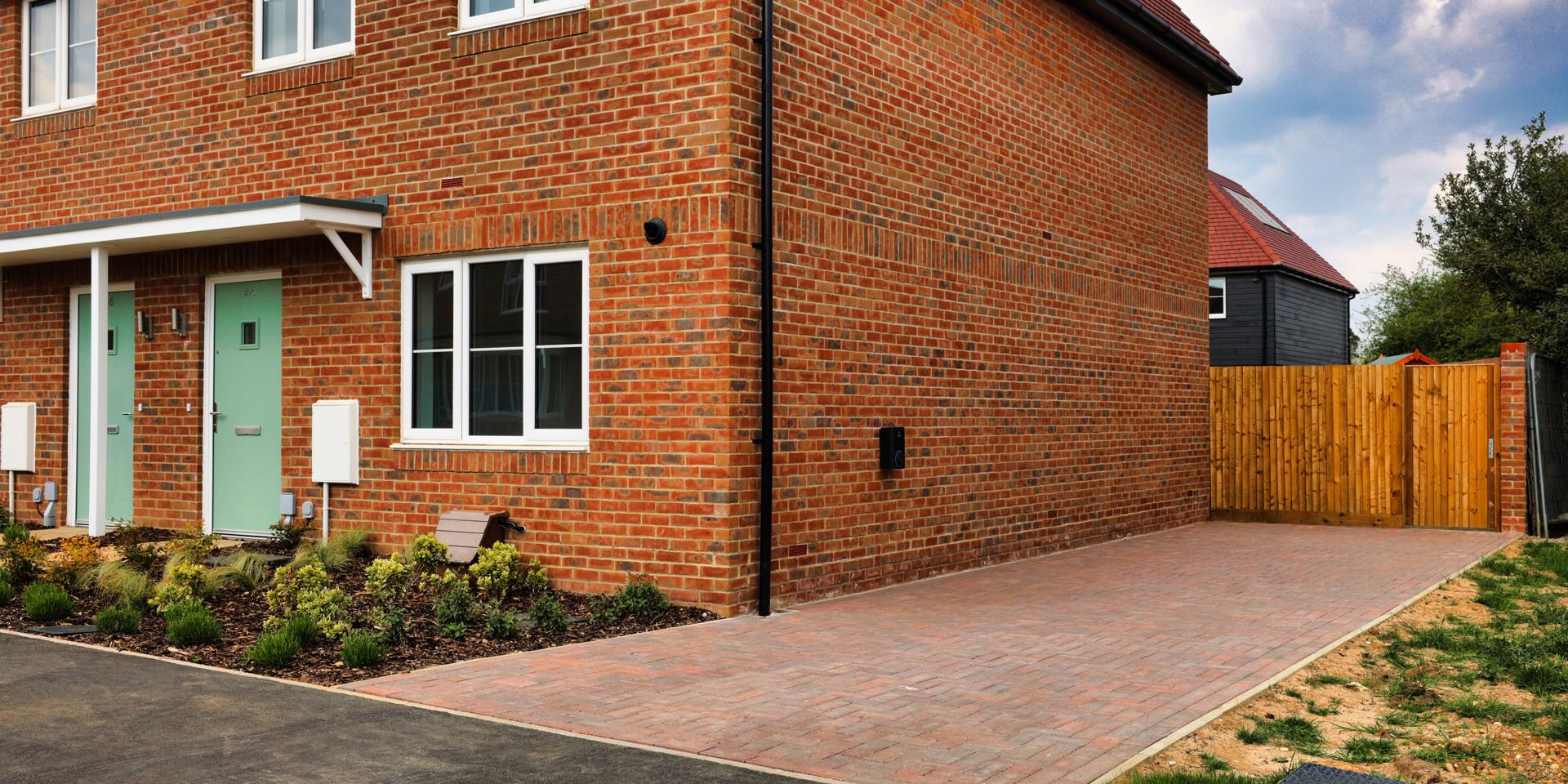 The driveway is to the side of the property and fits 2 cars