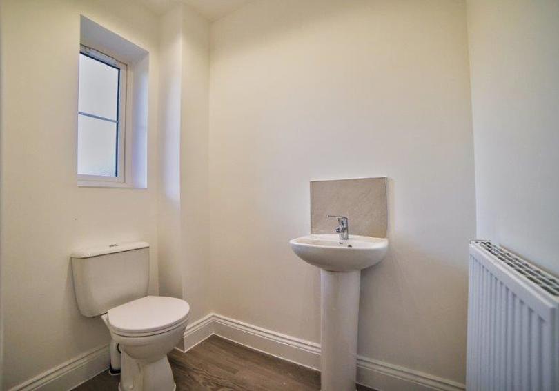A picture of the downstairs cloakroom including the toilet and wash hand basin