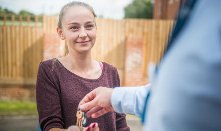 A new resident is being handed her keys by a member of staff