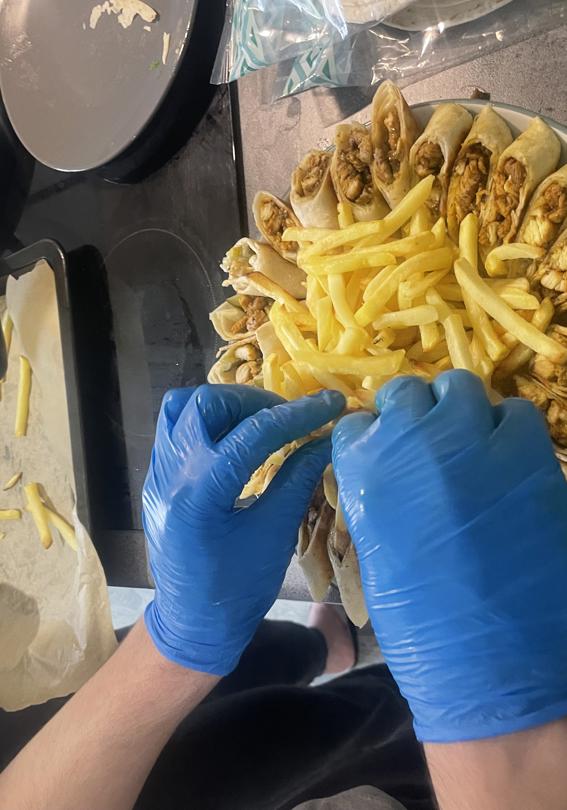 Participants plating up wraps and chips for the cook off