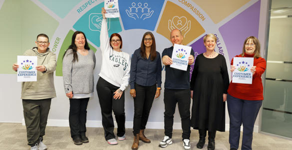 Four members of Hightown's Customer Experience Panel and Two Hightown staff holding up signs that read: Customer Experience Panel