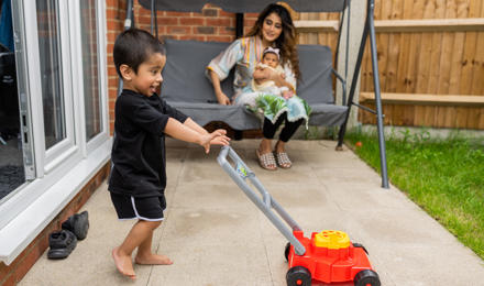 Hightown resident and her two young children playing in their garden