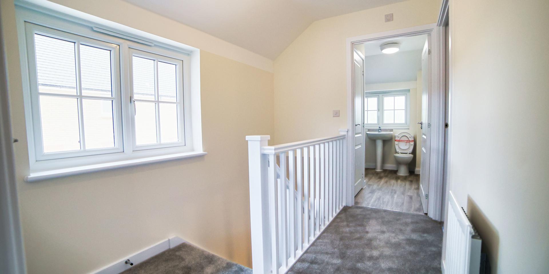 A view across the landing showing the bathroom doorway