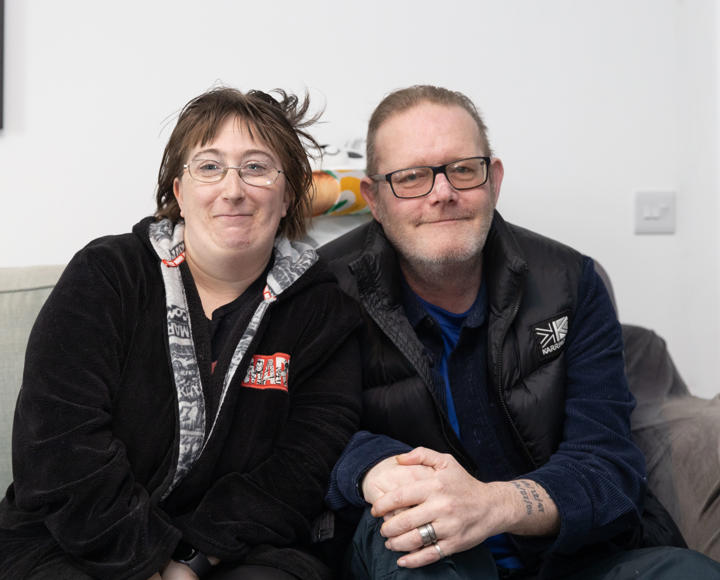 Two residents sat on their sofa