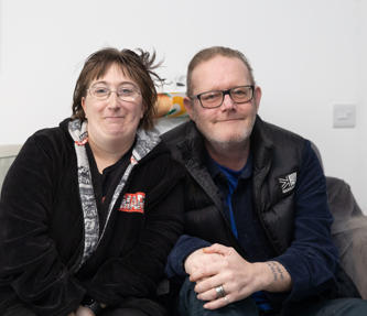 Two residents sat on their sofa