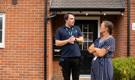 Hightown male property inspector talking to a female member of staff on an estate