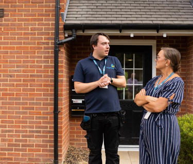 Hightown male property inspector talking to a female member of staff on an estate